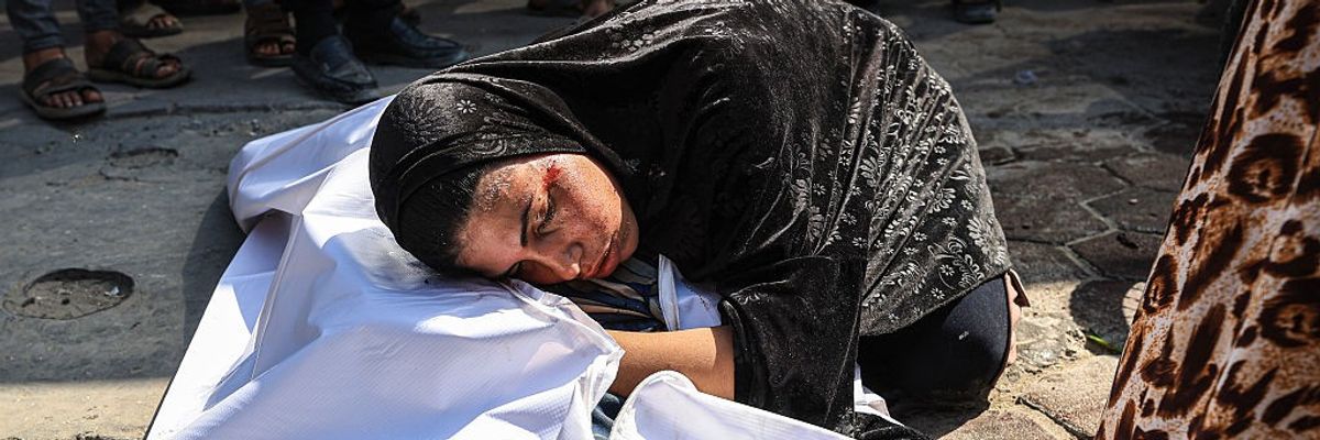A Palestinian woman grieves over the body of an Israeli attack in Gaza City