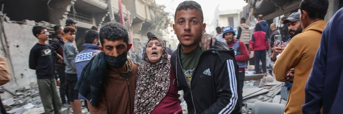 A Palestinian woman is carried from the site of an Israeli bombing in Gaza