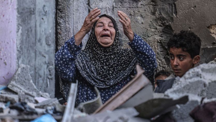 A Palestinian woman reacts following Israeli bombardment in Rafah