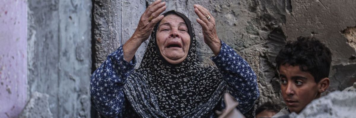 A Palestinian woman reacts following Israeli bombardment in Rafah