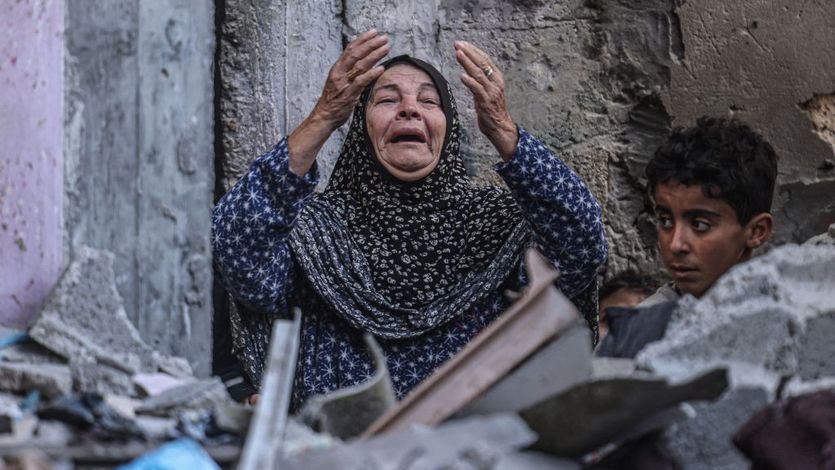 A Palestinian woman reacts following Israeli bombardment in Rafah
