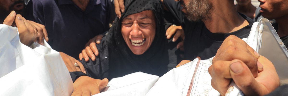 A Palestinian woman reacts over the corpse of a family member