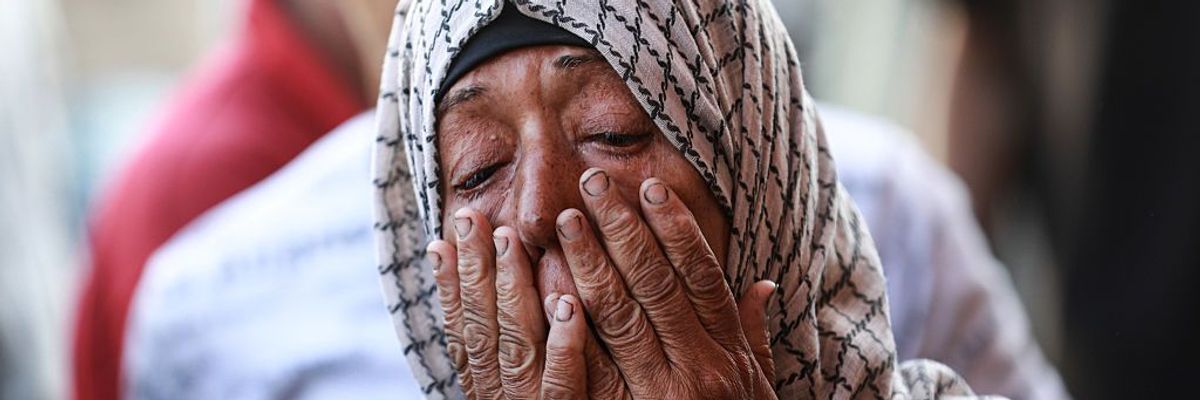 A Palestinian woman weeps for relatives killed in an Israeli strike