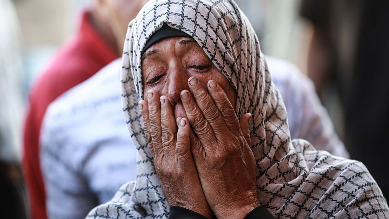 A Palestinian woman weeps for relatives killed in an Israeli strike