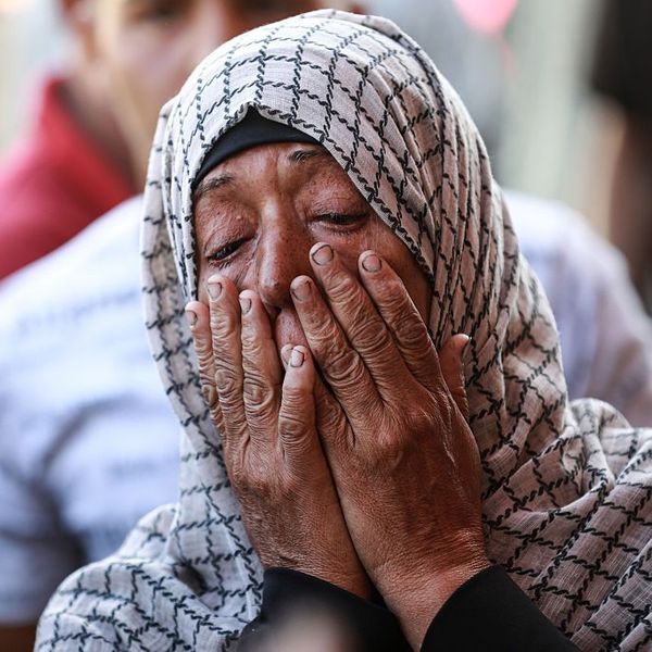 A Palestinian woman weeps for relatives killed in an Israeli strike