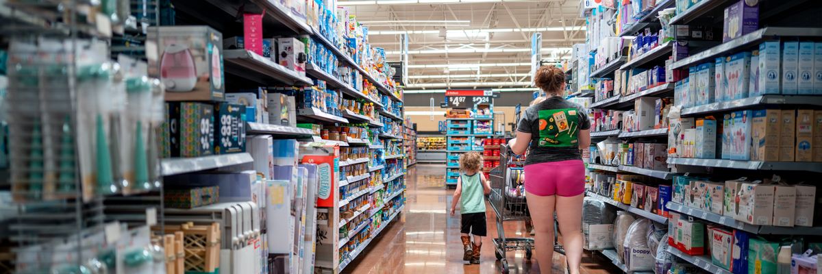 a parent and child in an aisle of walmart