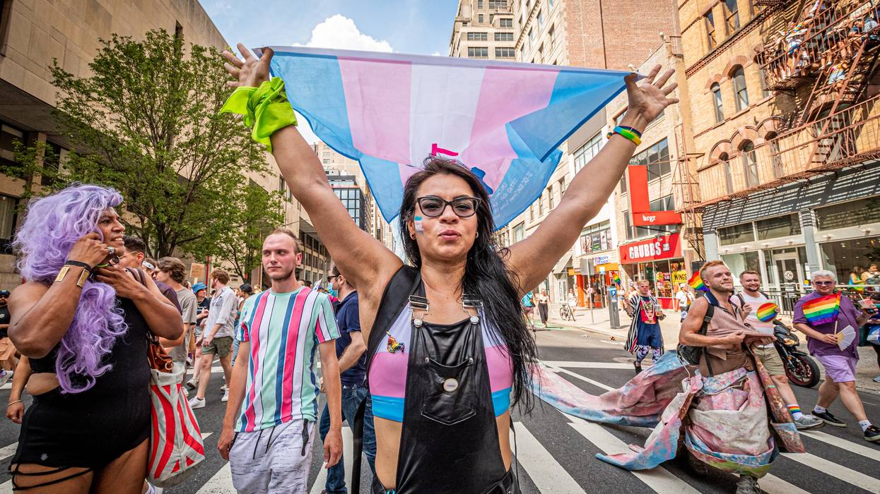 A participant carrying a Trans Flag seen at the march.