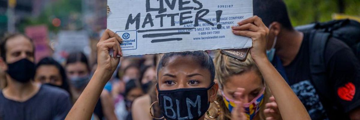 A participant holding a Black Lives Matter sign at a protest.