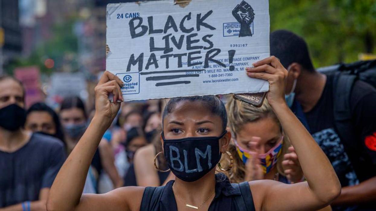 A participant holding a Black Lives Matter sign at a protest.