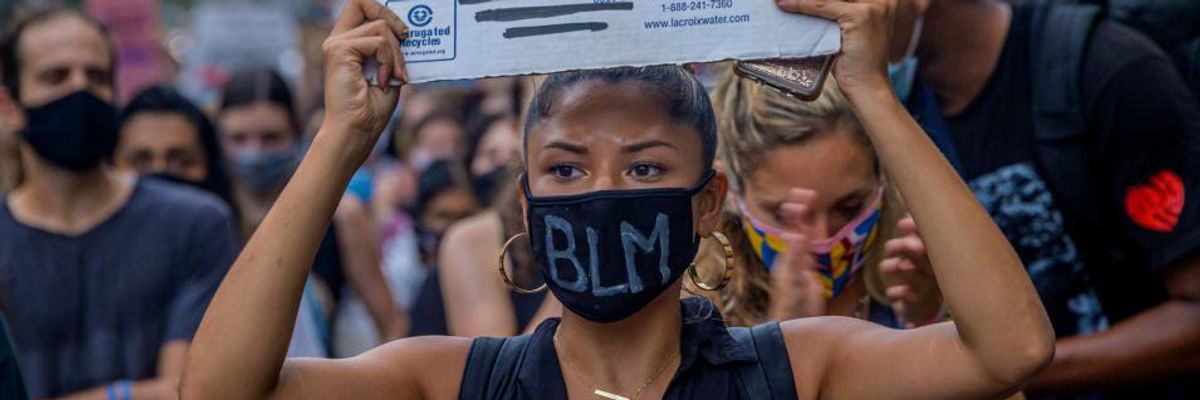 A participant holding a Black Lives Matter sign at the protest.
