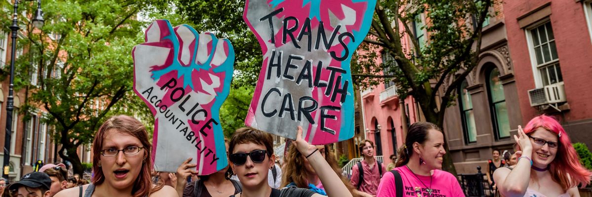 A participant holding a sign supporting Trans Rights during