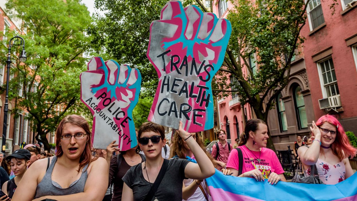 A participant holding a sign supporting Trans Rights during