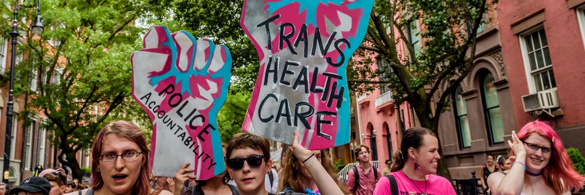 A participant holds a sign supporting transgender rights at a march