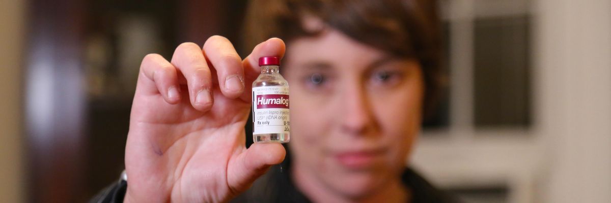A patient holds a vial of Humalog