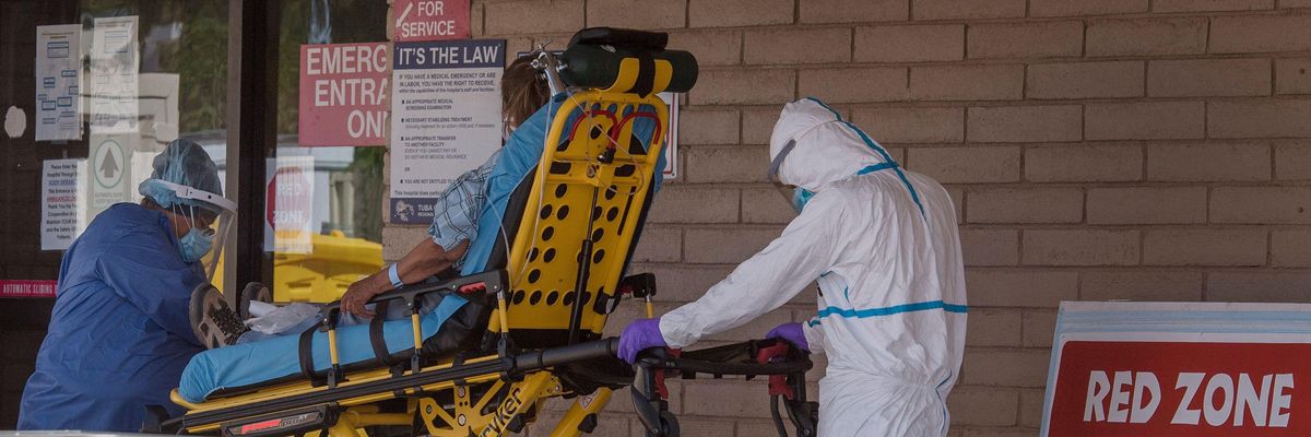 A patient is taken from an ambulance to the emergency room of a hospital in the Navajo Nation town of Tuba City, Arizona on May 24, 2020