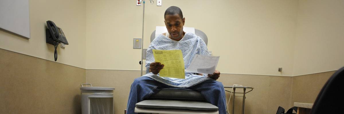 A patient looks over Medicaid paperwork .