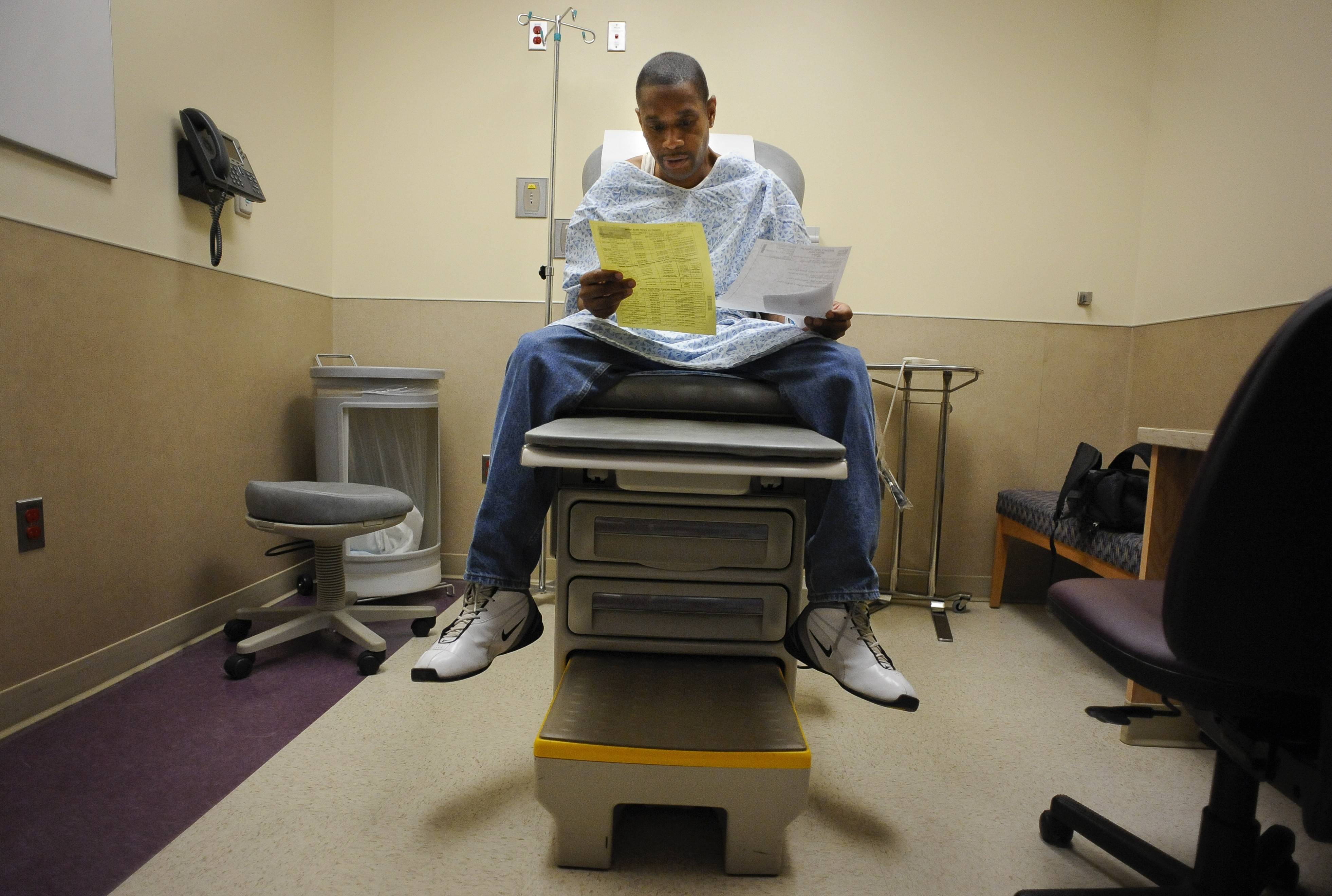 A patient looks over Medicaid paperwork .