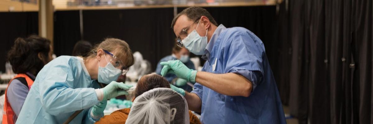A patient receives dental care at a free rural clinic.