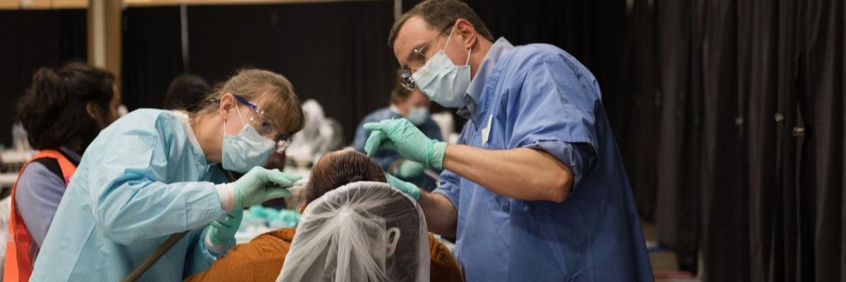 A patient receives dental care at a free rural clinic.