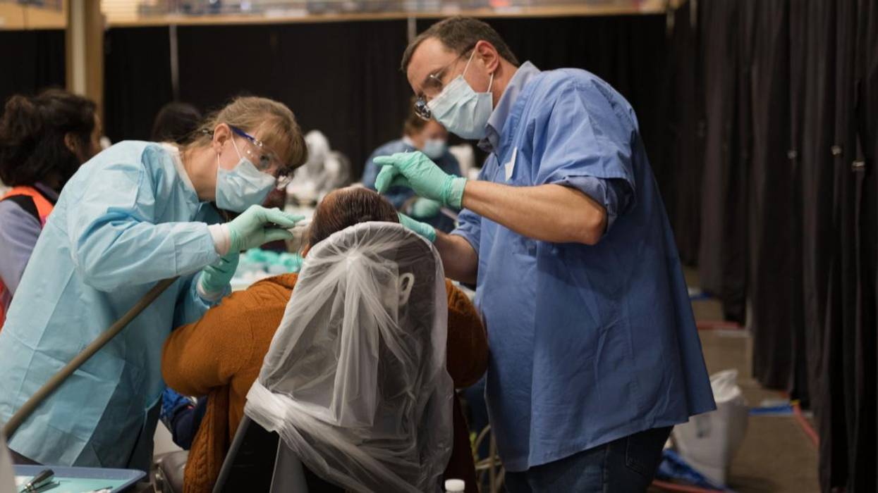 A patient receives dental care at a free rural clinic.