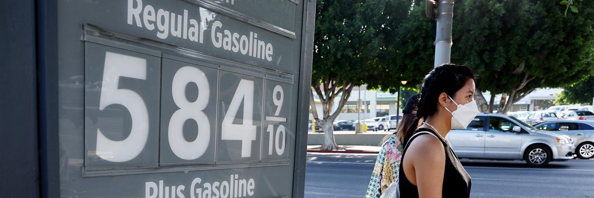 A pedestrian walks past a gas station advertising gas prices on March 25, 2022 in Los Angeles, California.