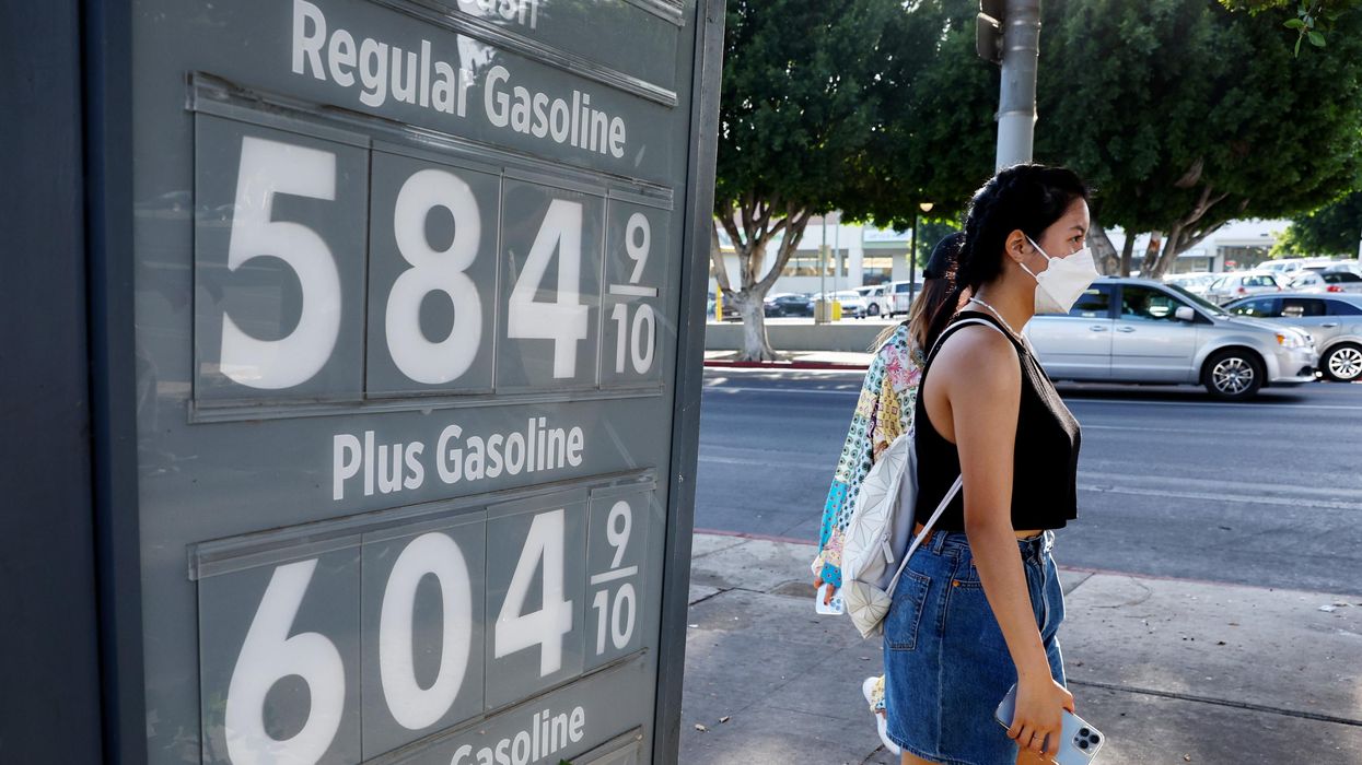 A pedestrian walks past a gas station advertising gas prices on March 25, 2022 in Los Angeles, California.