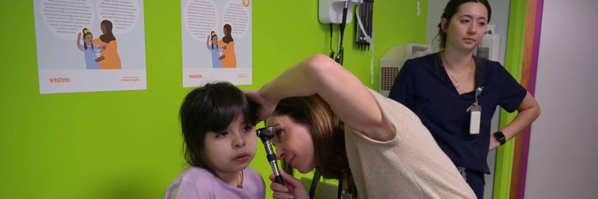 A pediatrician examines a child