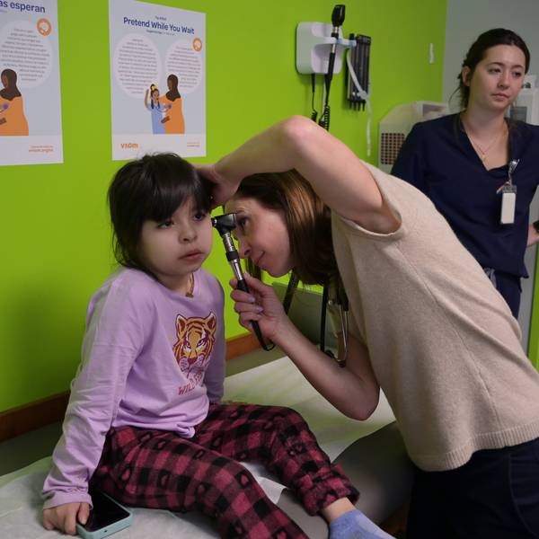 A pediatrician examines a child