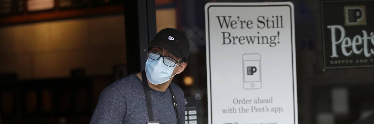 A Peet's Coffee & Tea employee fills takeout orders for customers in Oakland, California on May 18, 2020.