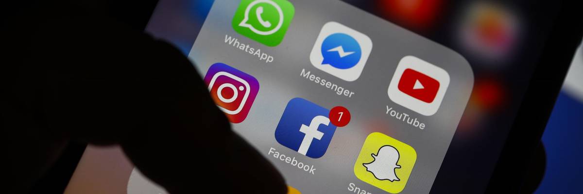 A person accesses a social media app on their smartphone.