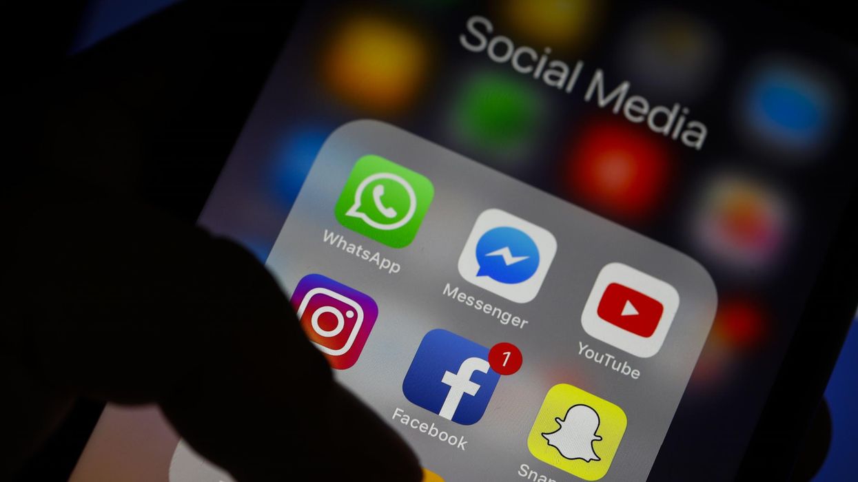 A person accesses a social media app on their smartphone.