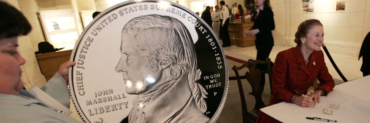 A person holding a big U.S. coin