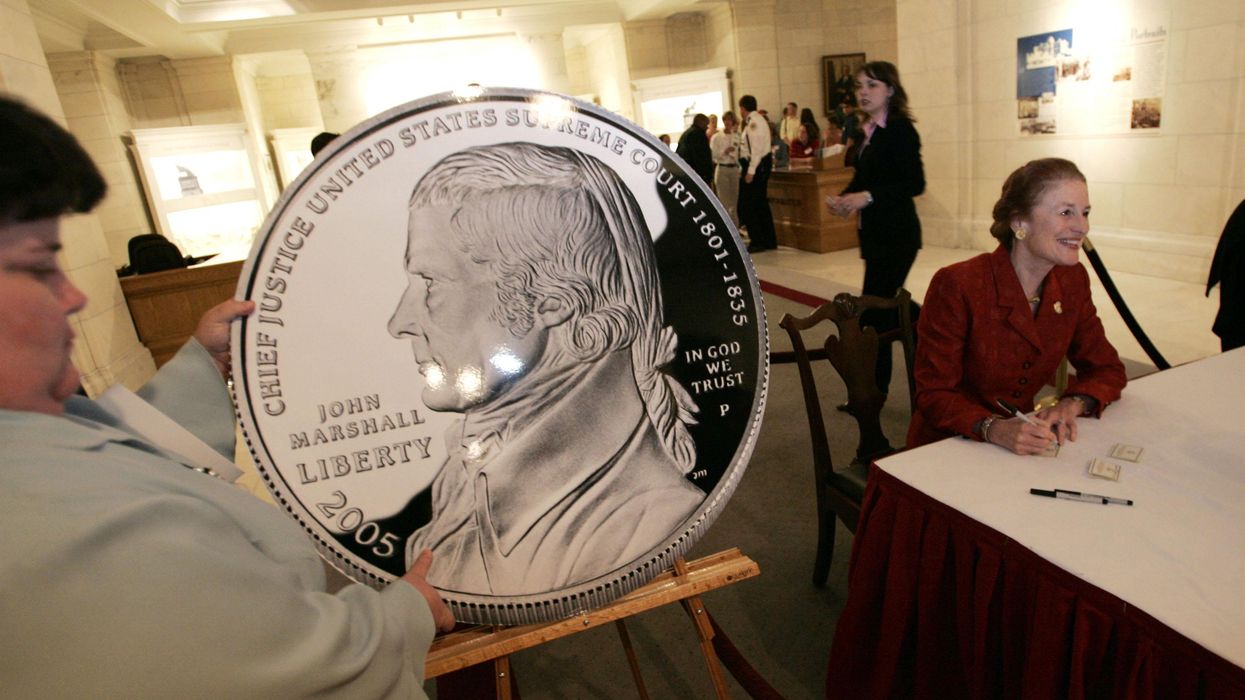 A person holding a big U.S. coin