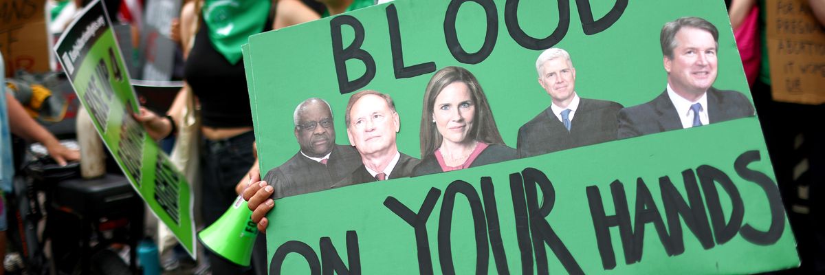 A person holds a sign condemning Supreme Court Justices Clarence Thomas, Samuel Alito, Amy Coney Barrett, Neil Gorsuch, and Brett Kavanaugh during a demonstration outside a Planned Parenthood clinic on July 16, 2022 in Santa Monica, California.