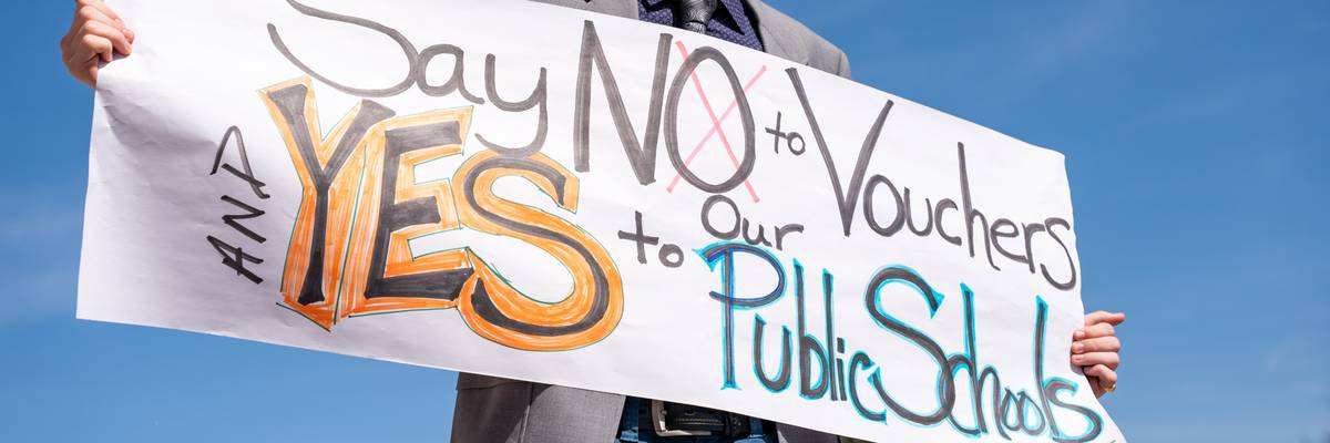 A person holds a sign during a protest outside of the Tennessee Capitol building