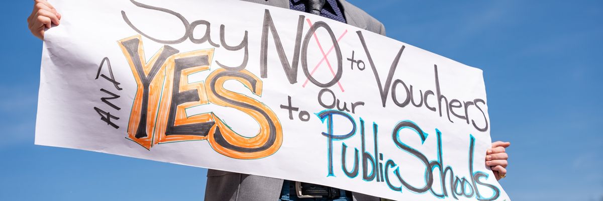 A person holds a sign during a protest outside of the Tennessee Capitol building