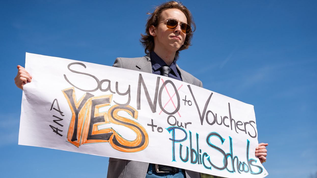 A person holds a sign during a protest outside of the Tennessee Capitol building