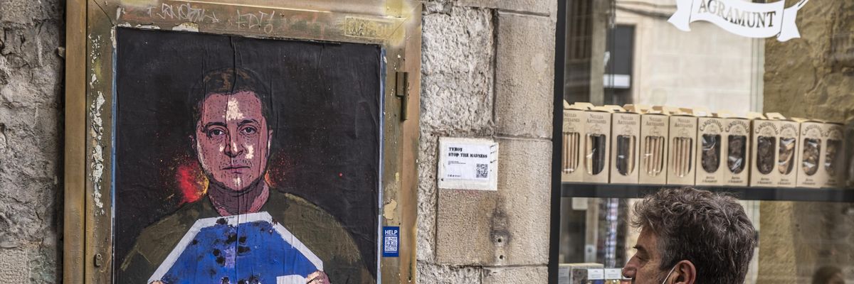 A person in Barcelona, Spain is seen observing the graphic representation of Ukrainian President Volodymyr Zelenskyy calling for an end to Russia's invasion on March 7, 2022.