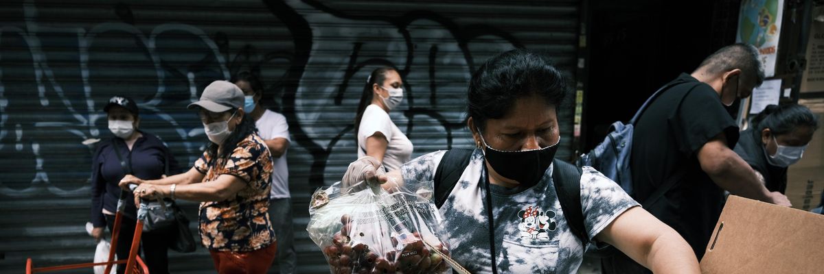 A person picks up food at a charity in New York City