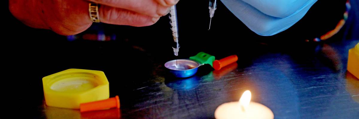 A person prepares an injection of fentanyl