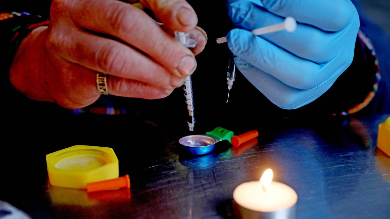 A person prepares an injection of fentanyl