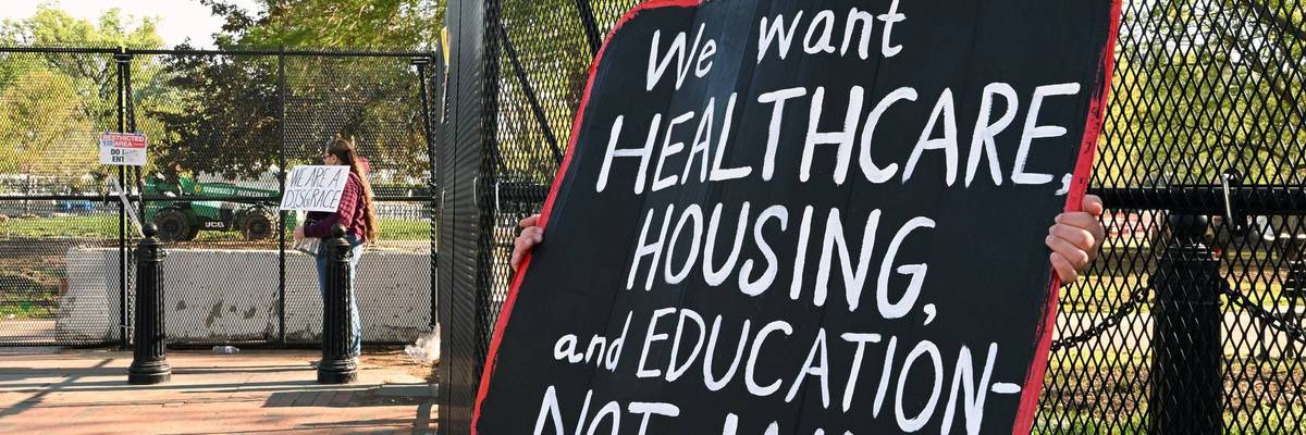 A person protests the Iran War outside the White House.