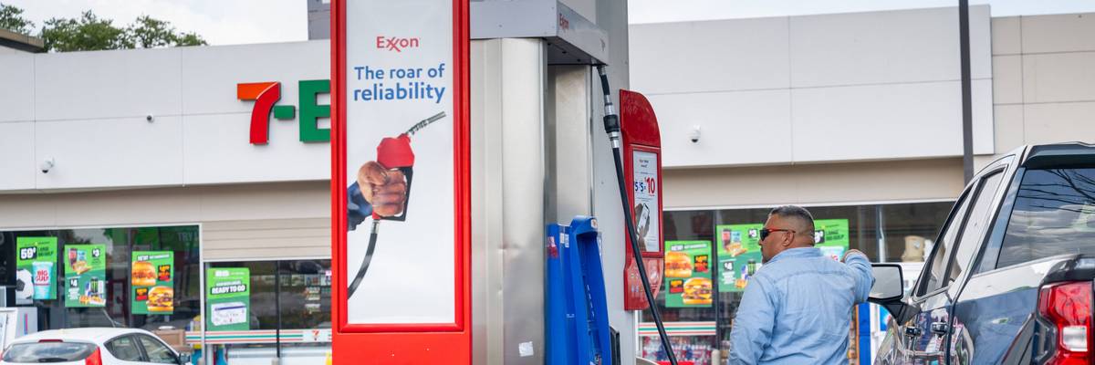 A person pumps gas at an Exxon station