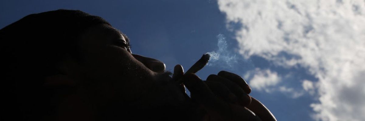 A person smokes marijuana