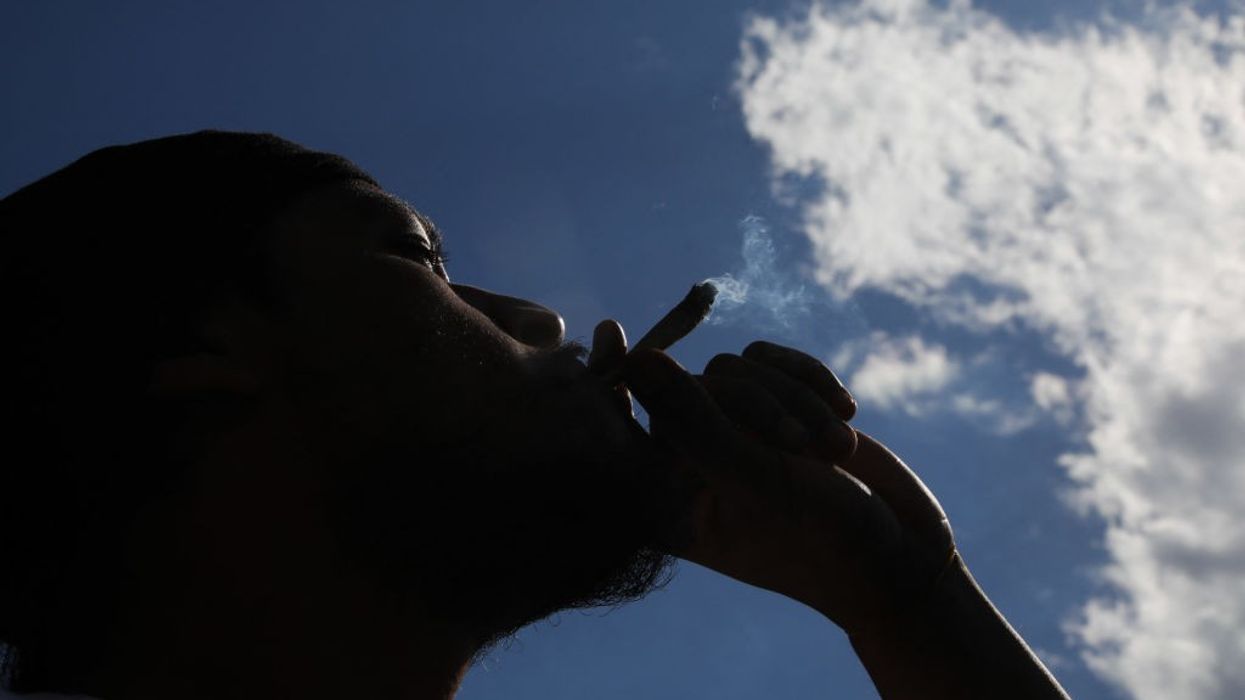 A person smokes marijuana