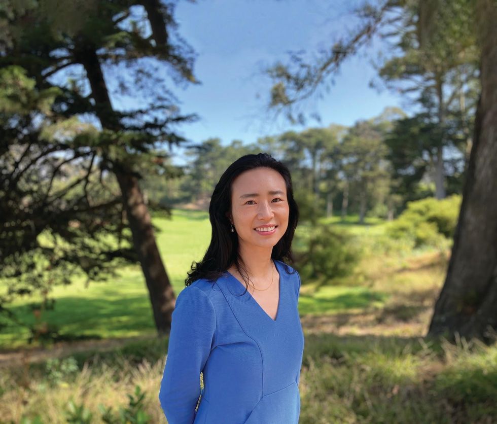 A person standing in a grassy area posing for the camera</p>\n<p>Description automatically generated