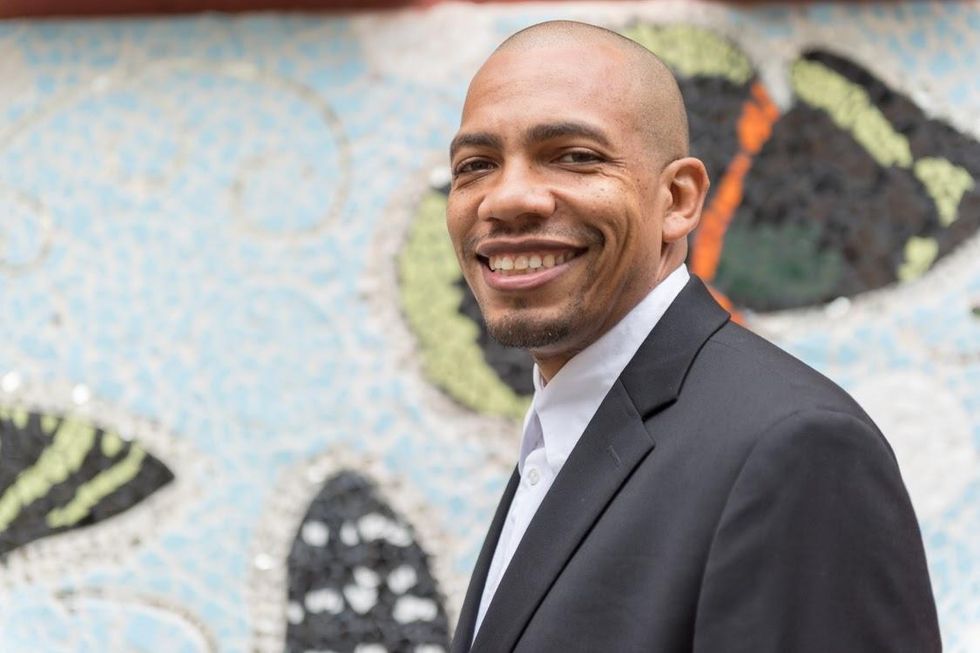 A person wearing a suit and tie</p>\n<p>Description automatically generated