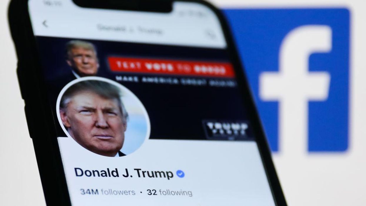 A phone featuring a Donald Trump is shown in front of a Facebook logo.