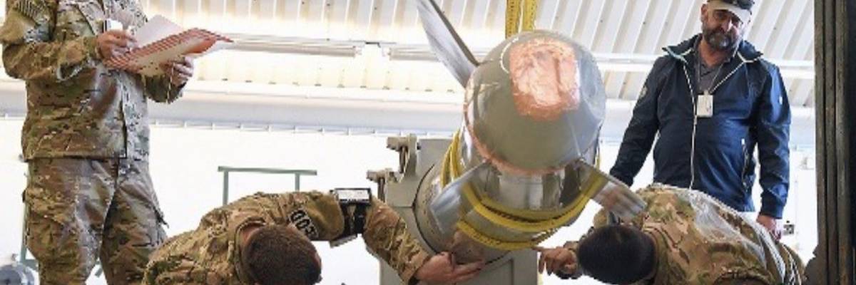 A photo in a Los Alamos National Laboratory student briefing from April 2022 shows four people inspecting what appears to be a damaged B61 nuclear bomb.