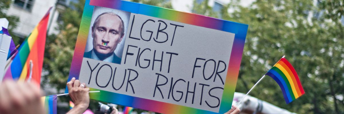 A placard reading "LGBT Fight for Your Rights" with Russian President Vladimir Putin is seen at a Berlin protest.